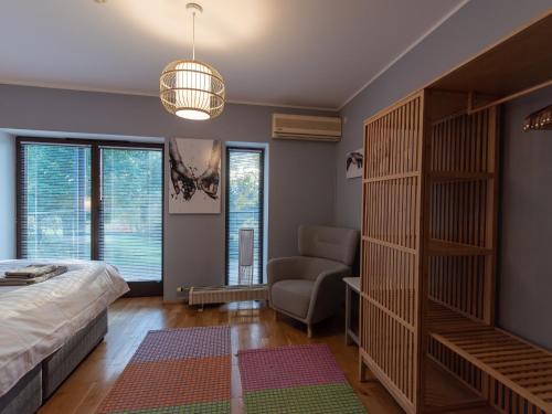 a bedroom with a bed and a chair and a couch at Pikk 45 in Otepää
