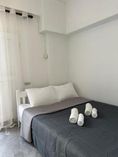 a bedroom with a bed with three towels on it at Casa Luna Luxury Apartment in Nea Moudania