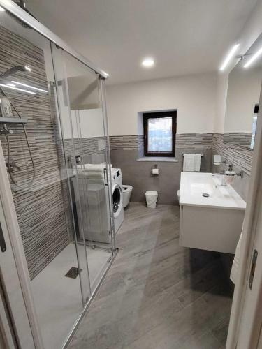 a bathroom with a shower and a toilet and a sink at 80062 Cute House in Meta