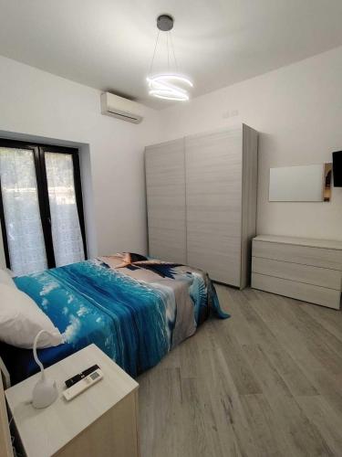 a bedroom with a bed and a table in it at 80062 Cute House in Meta