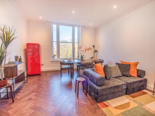 a living room with a couch and a table at Gated Mansion Apartment- Stylish, Quiet & Secure in Bromley
