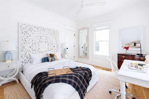 a white bedroom with a bed with a teddy bear on it at Best in Show in Atlanta