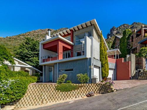 a house with a hill in the background at 5 Suikerbossie in Gordonʼs Bay