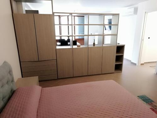 a bedroom with a bed and a large closet at Villetta da Amare in Imperia