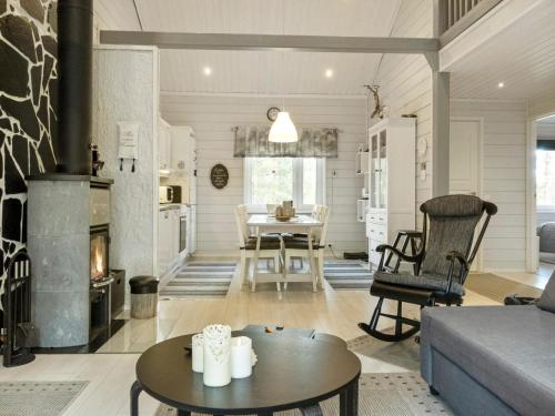 a living room with a fireplace and a table at Holiday Home Lapinvouti by Interhome in Levi