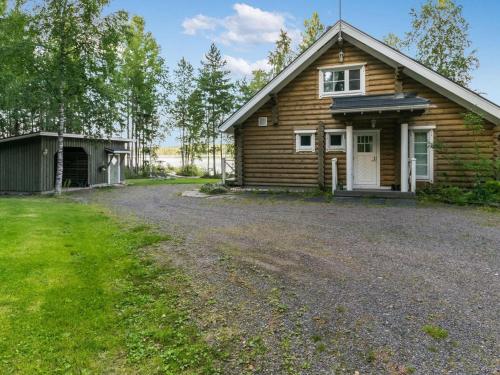 a log cabin with a driveway in front of it at Holiday Home Torniniemi by Interhome in Hiukkajoki