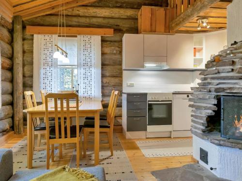 a kitchen and dining room with a table and a fireplace at Holiday Home Luppokero 1 by Interhome in Pyhätunturi