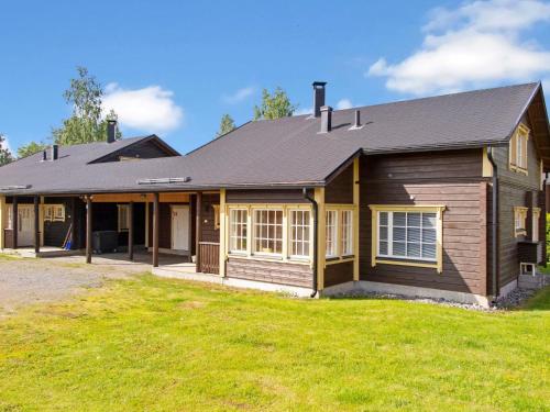 a house with a large yard in front of it at Holiday Home Tahkontupa by Interhome in Tahkovuori