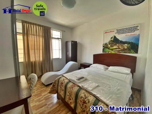 a bedroom with a bed and a table and a desk at HOSTAL HOGAR 3 Estrellas - CHEPÉN in Chepén