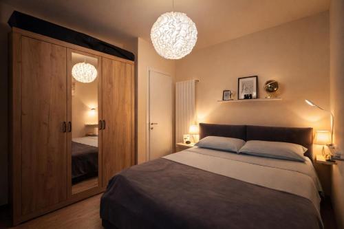 a bedroom with a bed and two chandeliers at Il Sogno terrazza panoramica in Massino Visconti