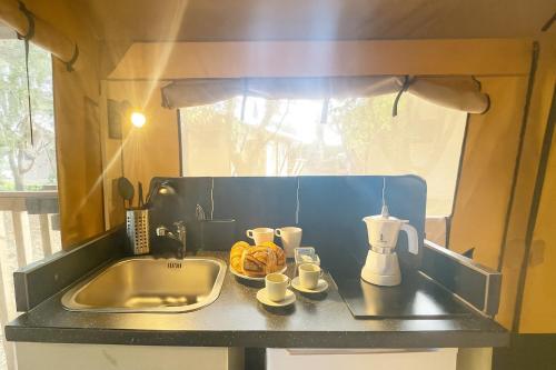 a kitchen counter top with a sink and a counter top at Glamping Il Poderino in Cecina