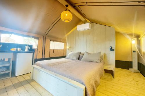 a bedroom with a bed in a small room at Glamping Il Poderino in Cecina