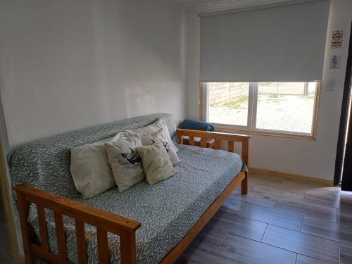 a bedroom with a bed with pillows and a window at Dorado Stey 2 in Río Grande