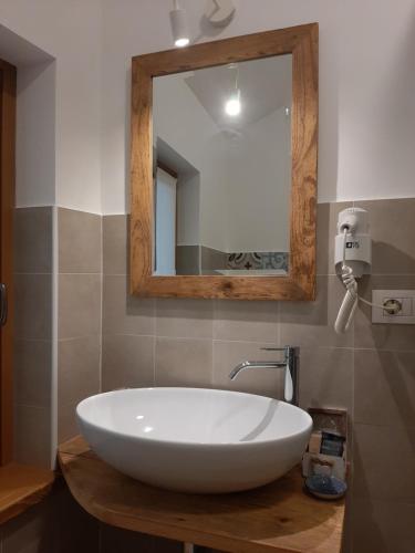 a bathroom with a white sink and a mirror at Osteria Al Ponte in Udine