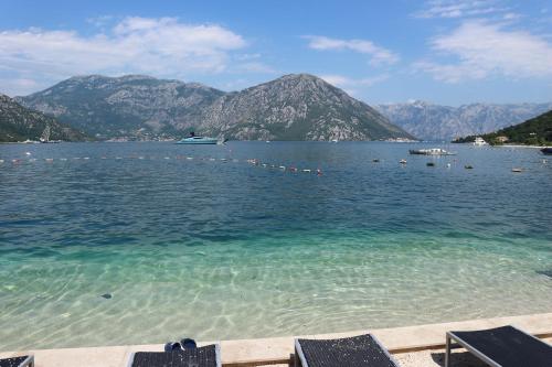a large body of water with mountains in the background at Lavender Bay Apartments D3 or D5 I by Andreas Crivellaro in Donji Morinj