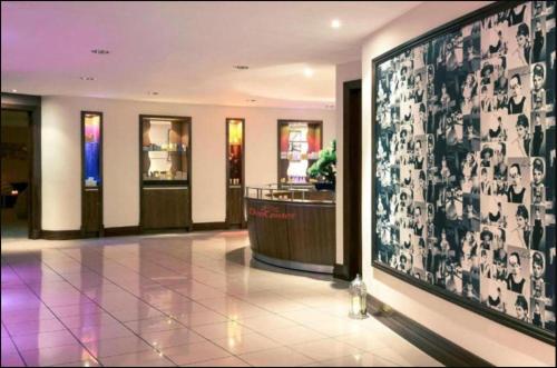a lobby with a large screen in a building at Central Cardiff Signature Collection by Dancenter in Cardiff