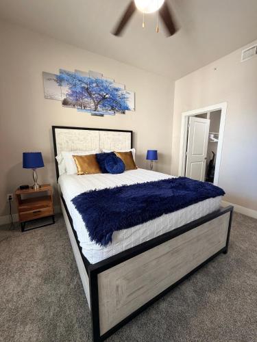 a bedroom with a large bed with a blue comforter at FIFA WORLD CUP! POOL VIEW! Near Dallas Love Field! Medical District! Downtown Dallas! in Dallas