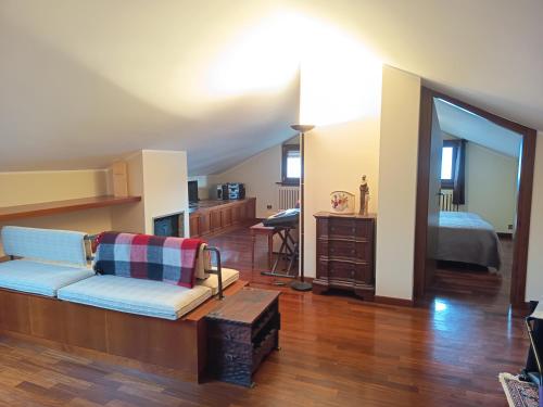 a living room with a couch and a bedroom at Suite Dream in Stresa