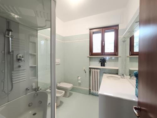 a bathroom with a sink and a toilet and a shower at Suite Dream in Stresa