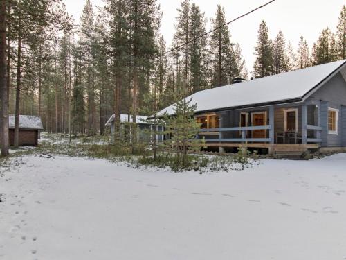 a cabin in the woods in the snow at Holiday Home Kuusenkolo by Interhome in Pyhätunturi