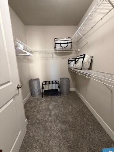 a walk in closet with two bags and two trash cans at FIFA WORLD CUP! POOL VIEW! Near Dallas Love Field! Medical District! Downtown Dallas! in Dallas