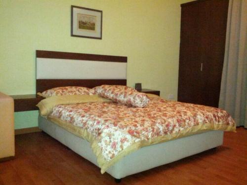 a bedroom with a bed with a floral comforter at Platinum Inn Bukitbintang in Kuala Lumpur