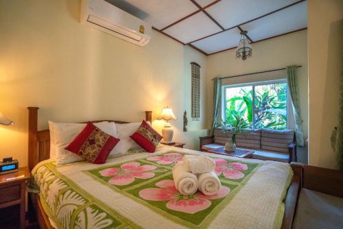 a bedroom with a bed with towels on it at The Aerie in Pang Mapha