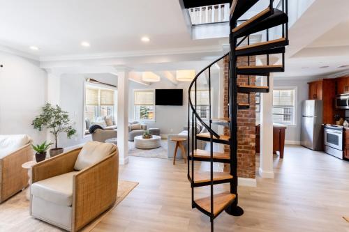a living room with a spiral staircase and a living room at The Newport Lofts - 410 Thames Street in Newport