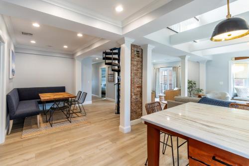 a living room with a couch and a table at The Newport Lofts - 410 Thames Street in Newport