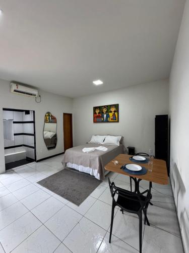 a bedroom with a bed and a table in it at AP 06 - Apartamento Estudio completo in Balsas