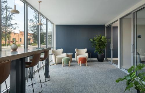 an office with chairs and a table and windows at Mint House Tampa Downtown by Kasa in Tampa