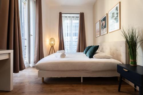 a bedroom with a large bed and a window at Chambre 3 La Madalena in Nice