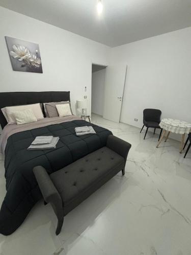 a bedroom with a large black bed and a table at BEB LA Perla in Sammichele di Bari