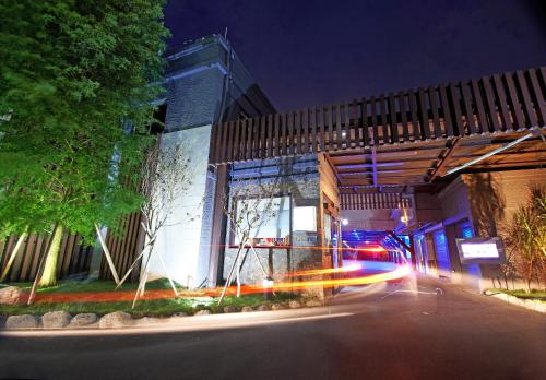 a police car in front of a building at night at Region Motel in Lugang