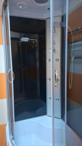 a glass door of a shower in a room at Hotel COLISEUM in Calafat