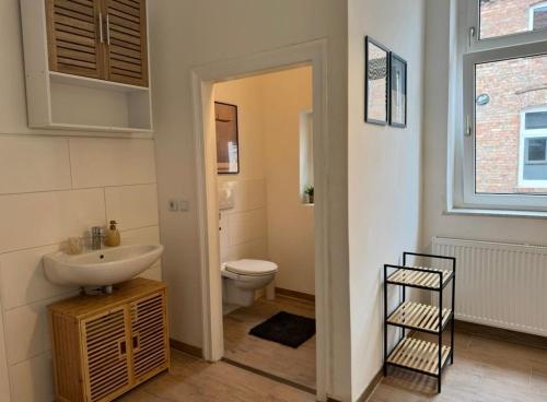 a bathroom with a sink and a toilet at Appartement "Peter" in Köthen mit 3 Schlafzimmern in Köthen