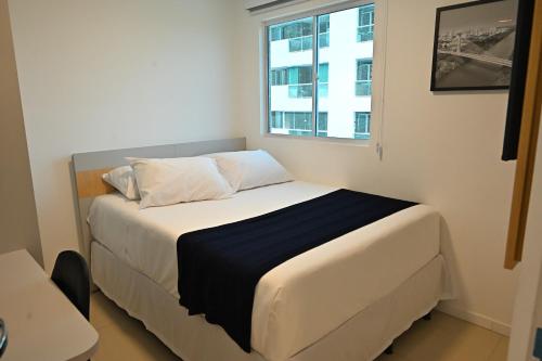 a bed in a small room with a window at Nobile Stays Ininga in Teresina
