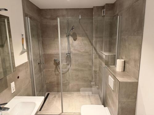 a bathroom with a shower and a toilet and a sink at Centrally located in Coesfeld in Coesfeld