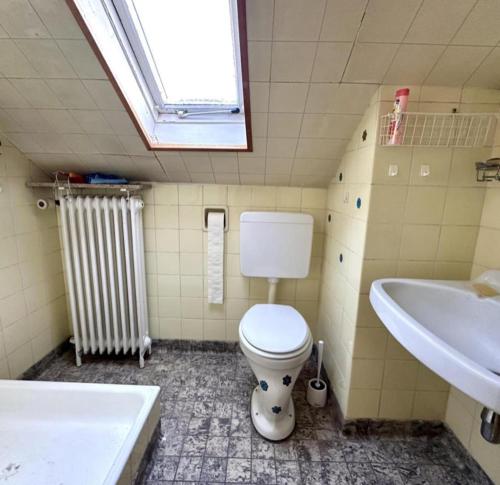 a bathroom with a toilet and a sink at Private Top Floor Apartment near Sana Klinik in Offenbach