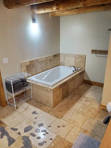 a bath tub in a bathroom with a tile floor at Sunset Bay Lodge in Abbeyville