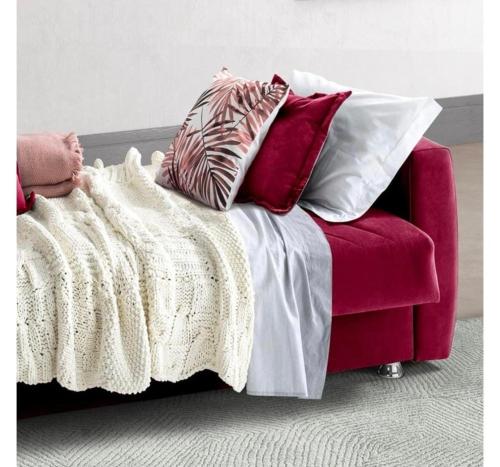 a red couch with many pillows on top of it at Mini white apartment in Scandicci