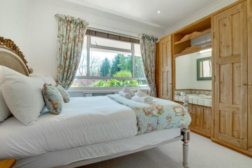 a bedroom with a large bed and a window at 4 Bed in Ovingdean oc-bbvale in Rottingdean