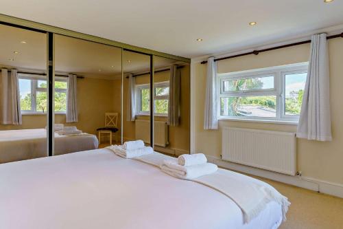 a bedroom with a large white bed with mirrors at 3 Bed in Mumbles oc-b27725 in The Mumbles