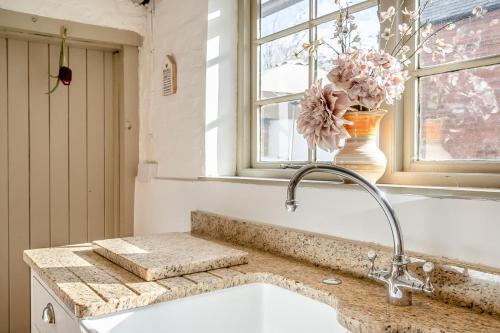 a kitchen with a sink and a vase with flowers at 4 Bed in Alcester oc-s30997 in Alcester