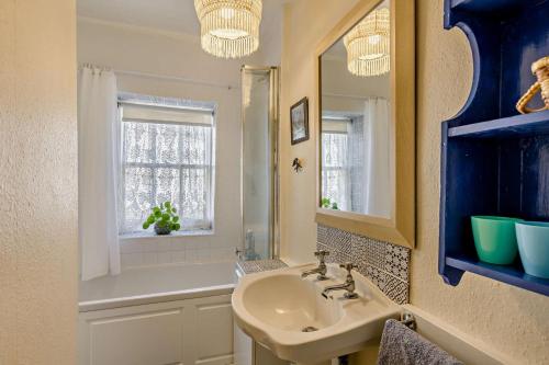 a bathroom with a sink and a mirror and a tub at 2 Bed in Brecon oc-t32728 in Brecon