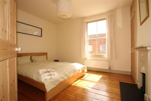 a bedroom with a bed and a window at Gorgeous House by City Walls in Canterbury
