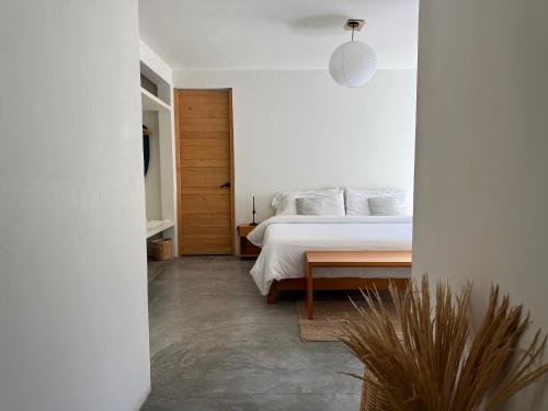 a bedroom with a bed and a wooden table at Casa 821 Guest House in Oaxaca City