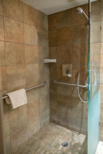 a bathroom with a shower with a glass door at Banff Caribou Lodge and Spa in Banff
