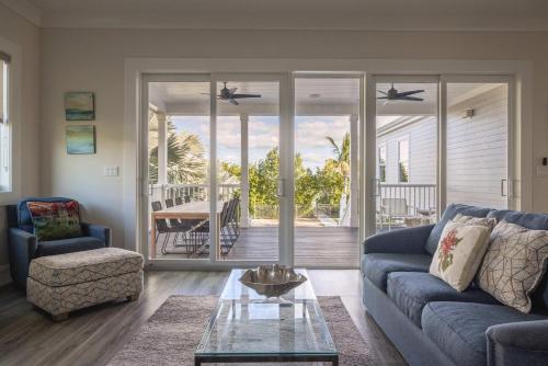 a living room with a blue couch and a table at Seagate House -Waterfront w Dock in Key West