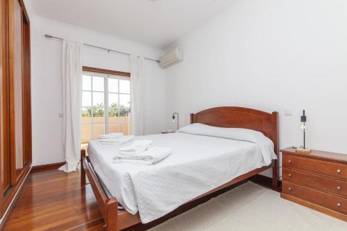 a white bedroom with a bed and a window at A49 - Anastasia Apartment in Lagos in Lagos